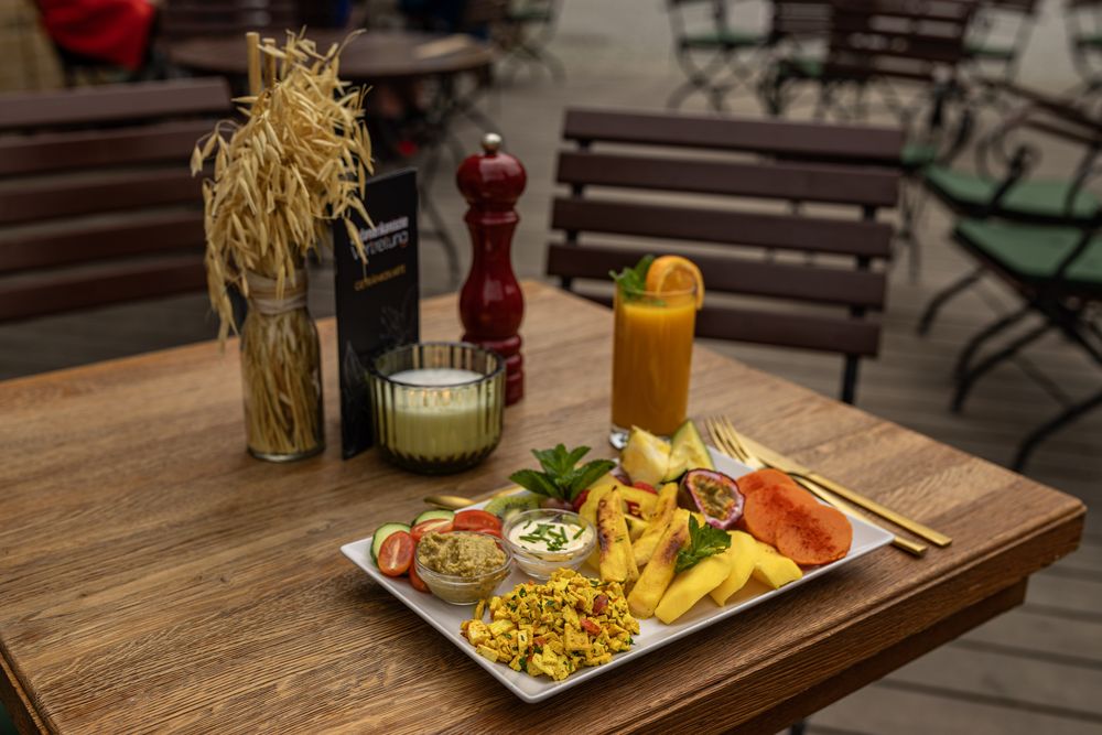 Veganes Hausangebot mit Tofu-Rührei, Mango, Avocado und Maracuja-Saft